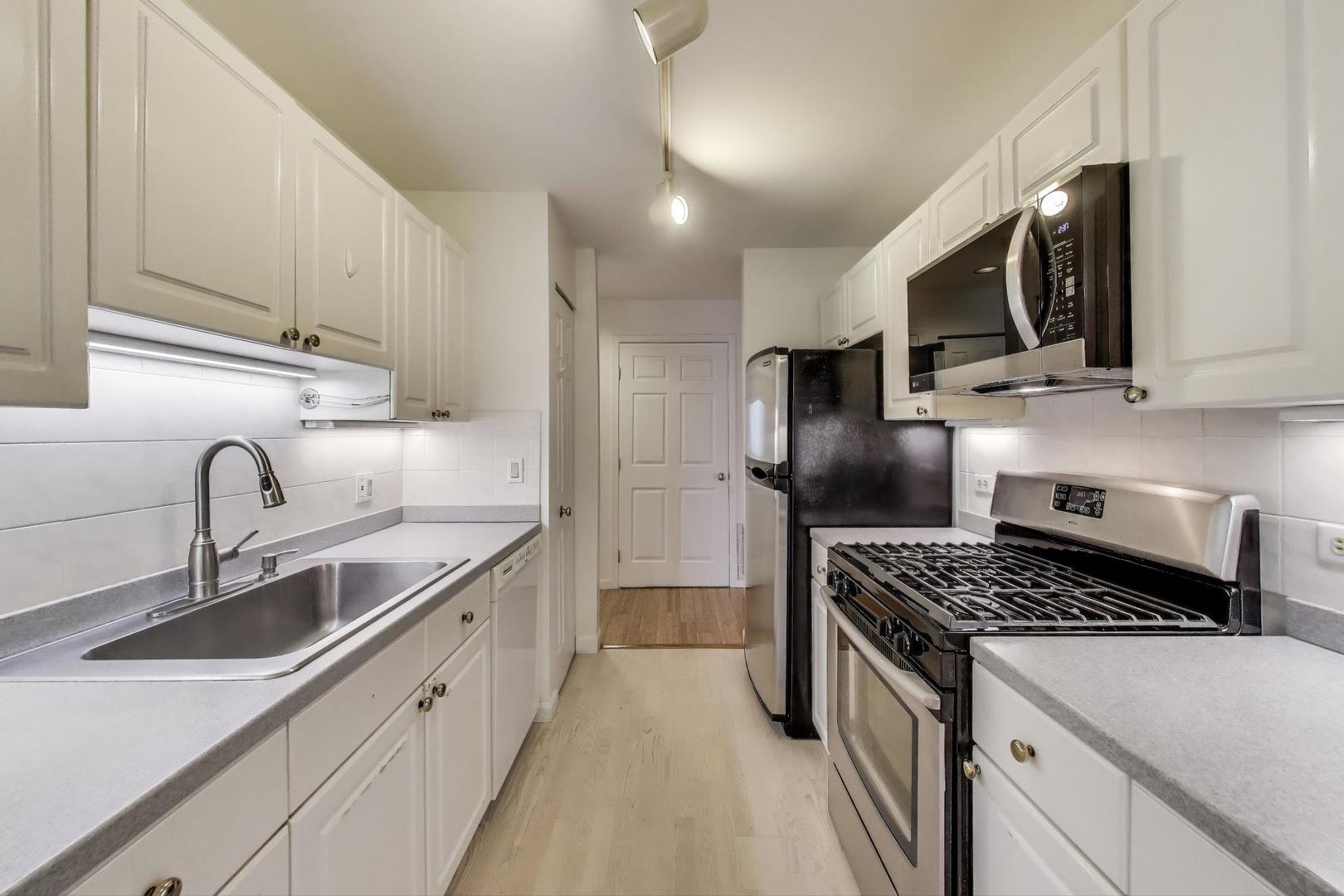 2720 Central Street, Unit 4C Evanston, IL 60201 - Photo 9 of 25 a kitchen with stainless steel appliances granite countertop a sink stove and refrigerator