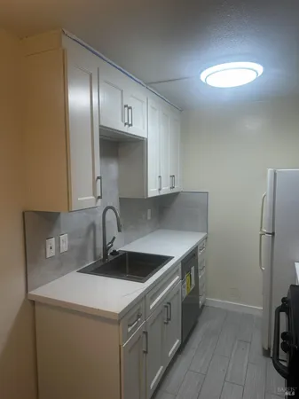 a kitchen that has a sink and a stove