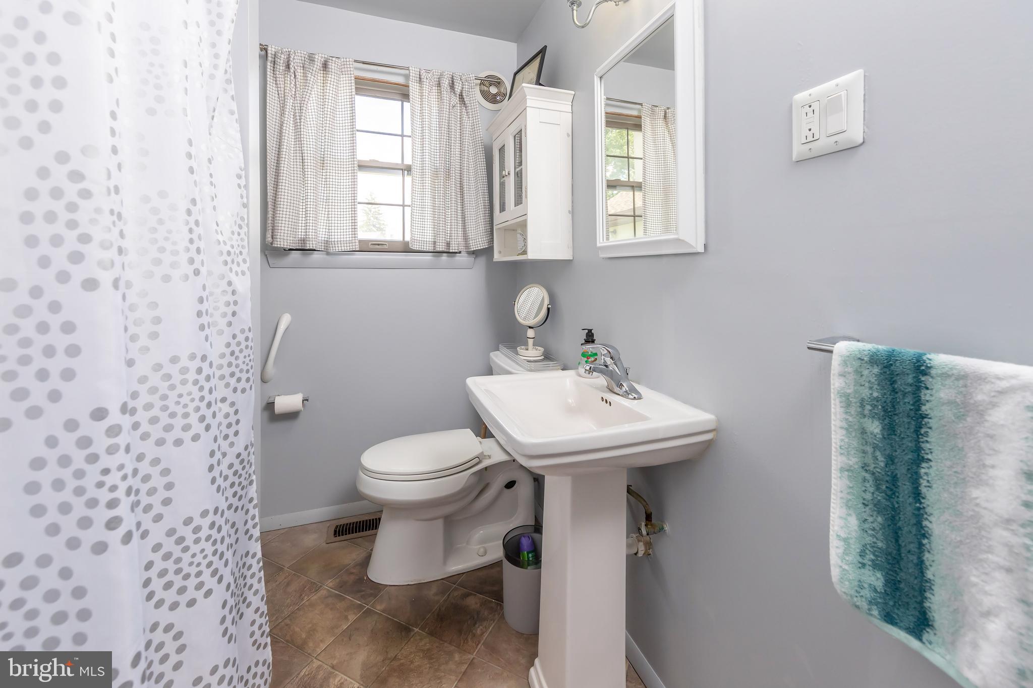 23 Randolph Road West Deptford, NJ 08096 - Photo 11 of 18 a bathroom with a sink toilet and a mirror