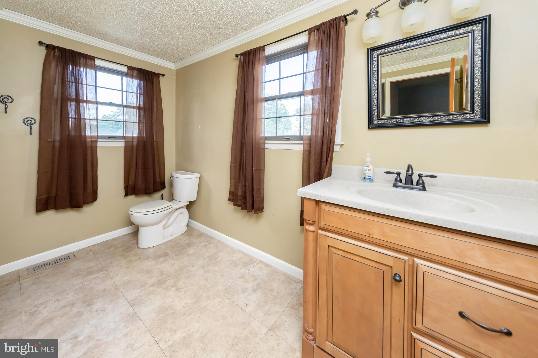 23 Randolph Road West Deptford, NJ 08096 - Photo 14 of 18 a bathroom with a toilet sink and mirror