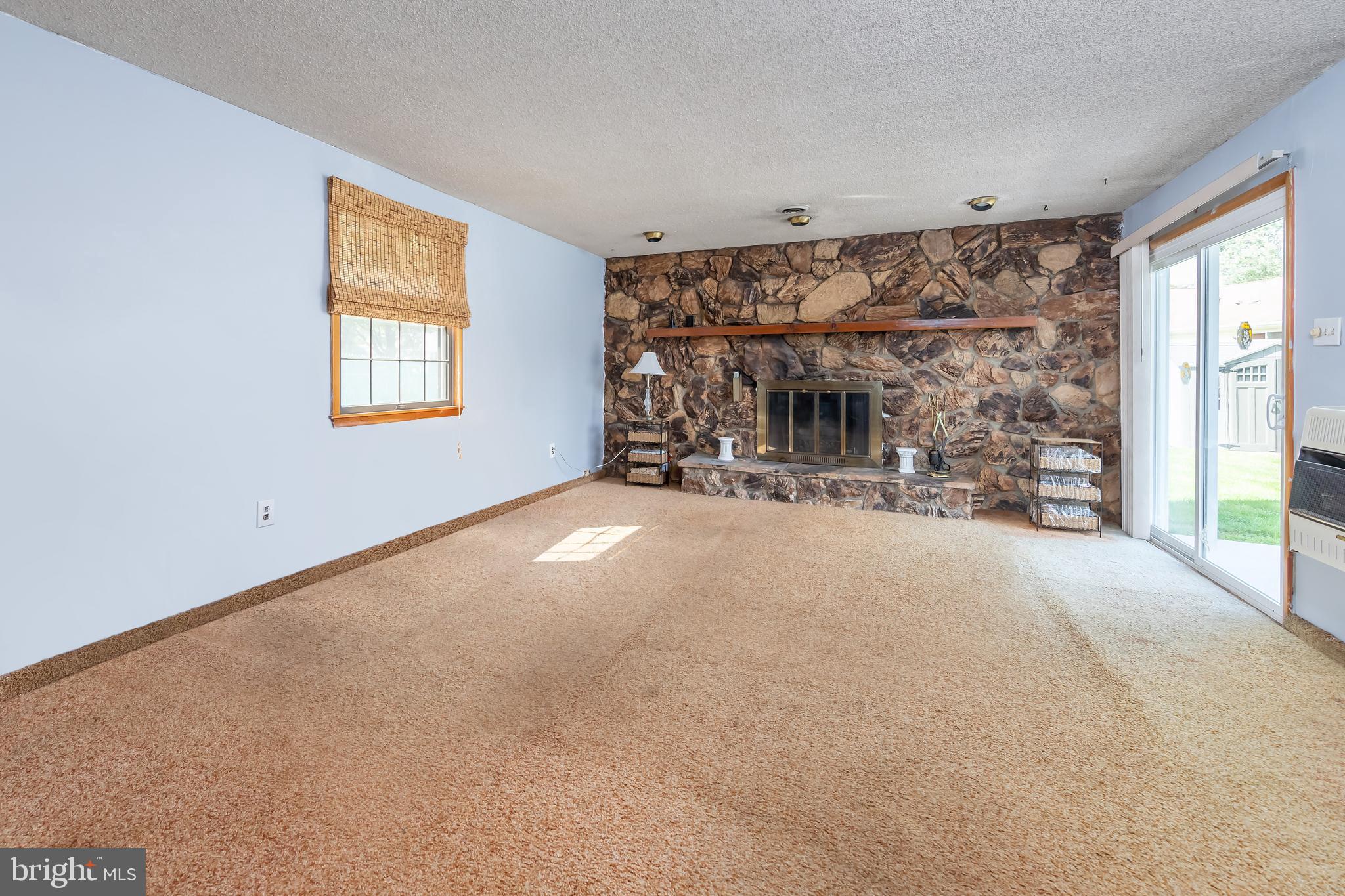 23 Randolph Road West Deptford, NJ 08096 - Photo 7 of 18 a view of a livingroom with a fireplace and window