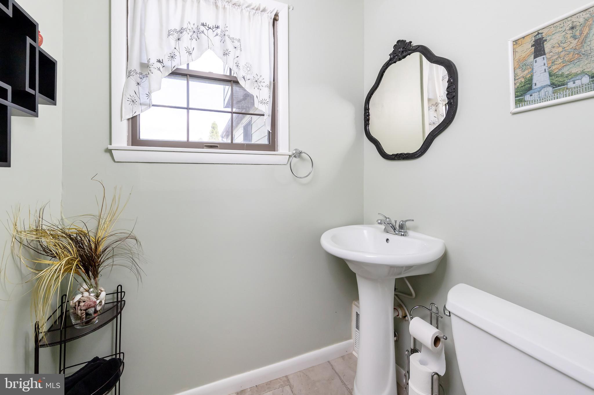 23 Randolph Road West Deptford, NJ 08096 - Photo 8 of 18 a bathroom with a sink a mirror and a toilet
