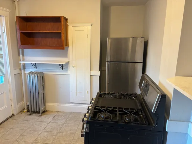 a kitchen with a stove and a refrigerator