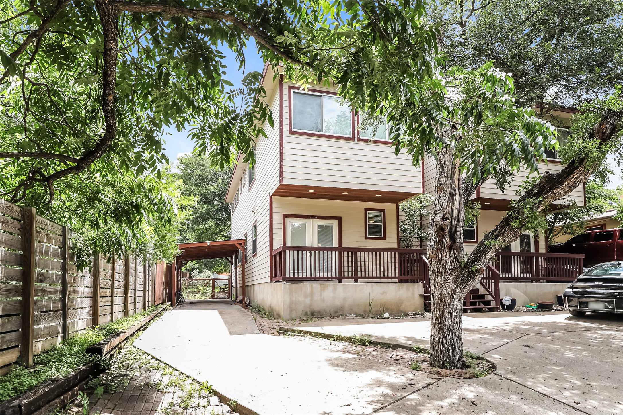 1701 Sanchez Street, Unit A Austin, TX 78702 - Photo 17 of 19 Natural wood accents and railings adorn this inviting two-story home with a covered side carport.