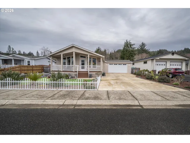 a front view of a house with a garden and pathway
