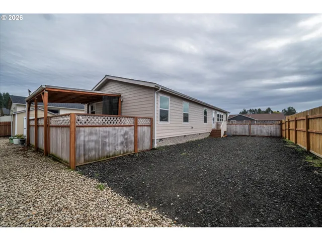 a view of a house with a backyard and deck