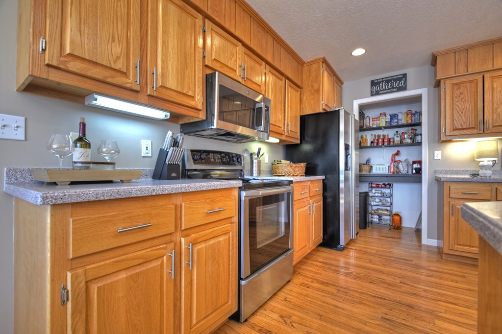 3725 Ada Street Blue Ridge, GA 30513 - Photo 15 of 75 a kitchen with stainless steel appliances granite countertop a refrigerator and cabinets