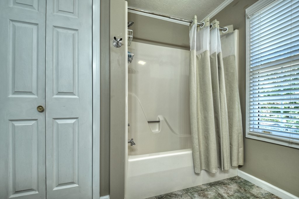 3725 Ada Street Blue Ridge, GA 30513 - Photo 21 of 75 a bathroom with a glass shower door and a bathtub