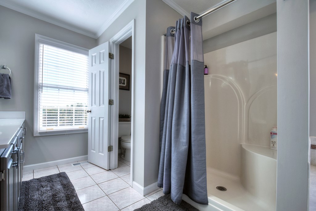 3725 Ada Street Blue Ridge, GA 30513 - Photo 42 of 75 a bathroom with a glass shower door and a bathtub