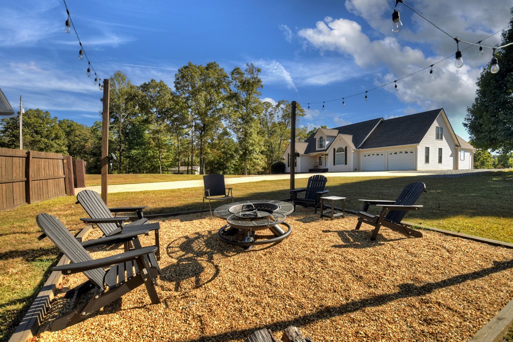3725 Ada Street Blue Ridge, GA 30513 - Photo 45 of 75 a roof deck with table and chairs with wooden floor and fence