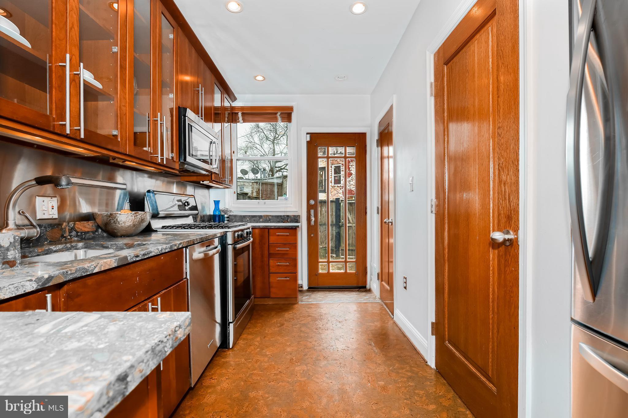 964 Florida Avenue Northwest Washington, DC 20001 - Photo 11 of 27 a kitchen with stainless steel appliances granite countertop a refrigerator a stove and a sink