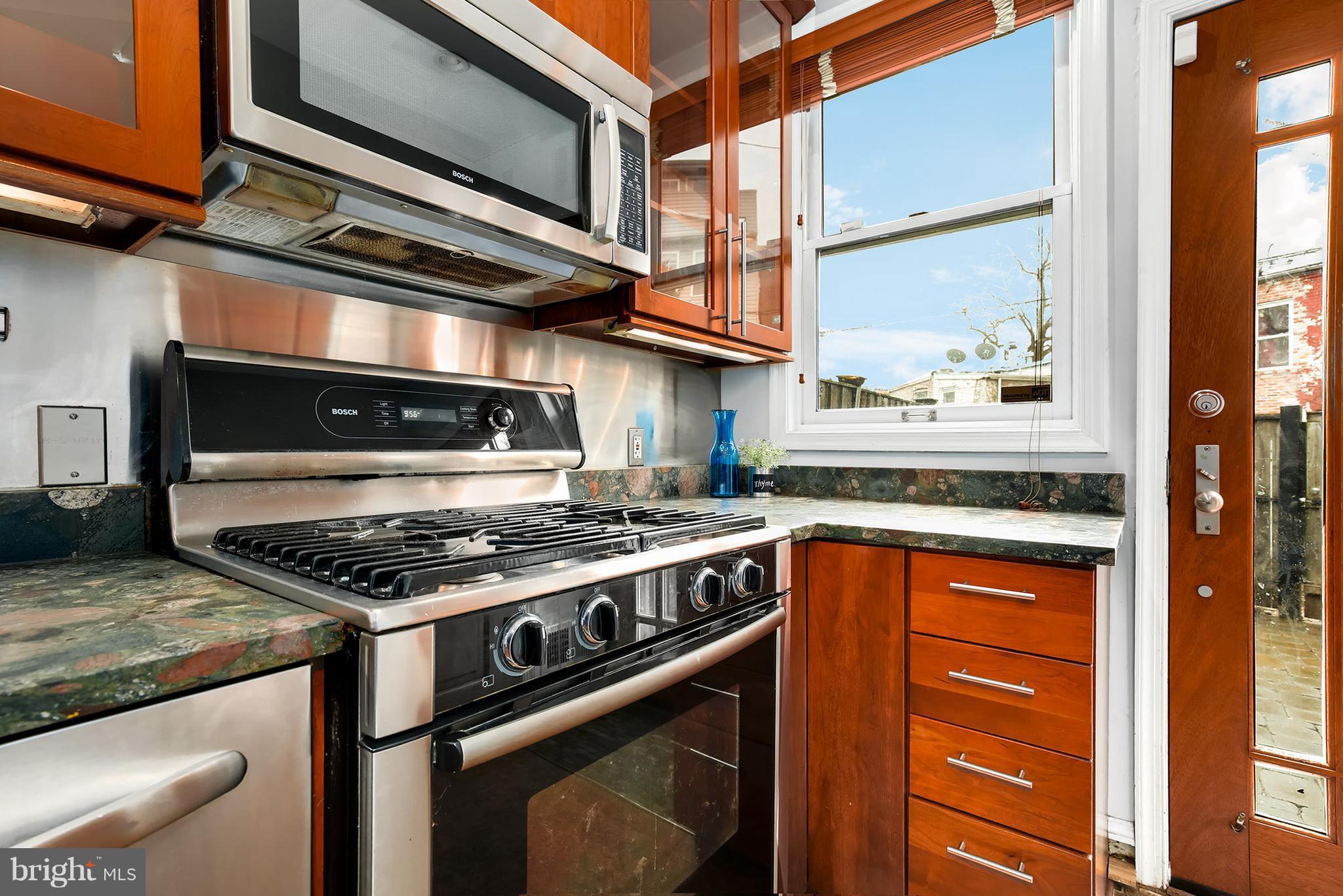 964 Florida Avenue Northwest Washington, DC 20001 - Photo 13 of 27 a kitchen with stainless steel appliances granite countertop a stove and a microwave
