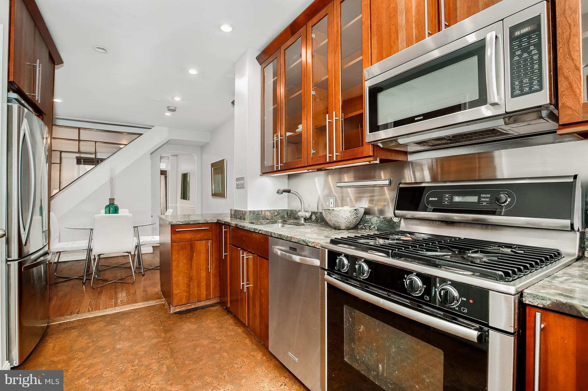 964 Florida Avenue Northwest Washington, DC 20001 - Photo 15 of 27 a kitchen with stainless steel appliances granite countertop a stove and a microwave