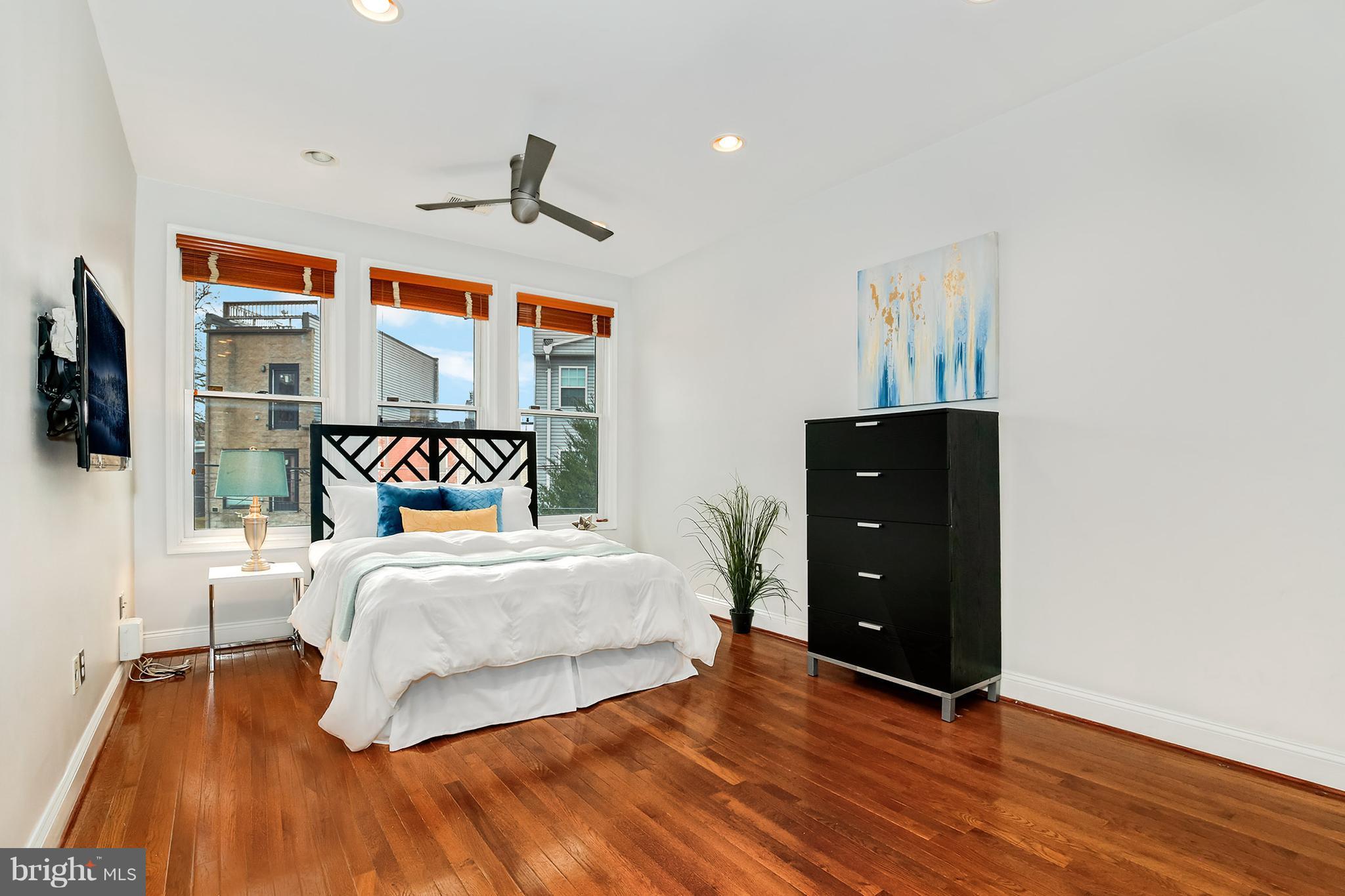 964 Florida Avenue Northwest Washington, DC 20001 - Photo 20 of 27 a bedroom with a bed and wooden floor
