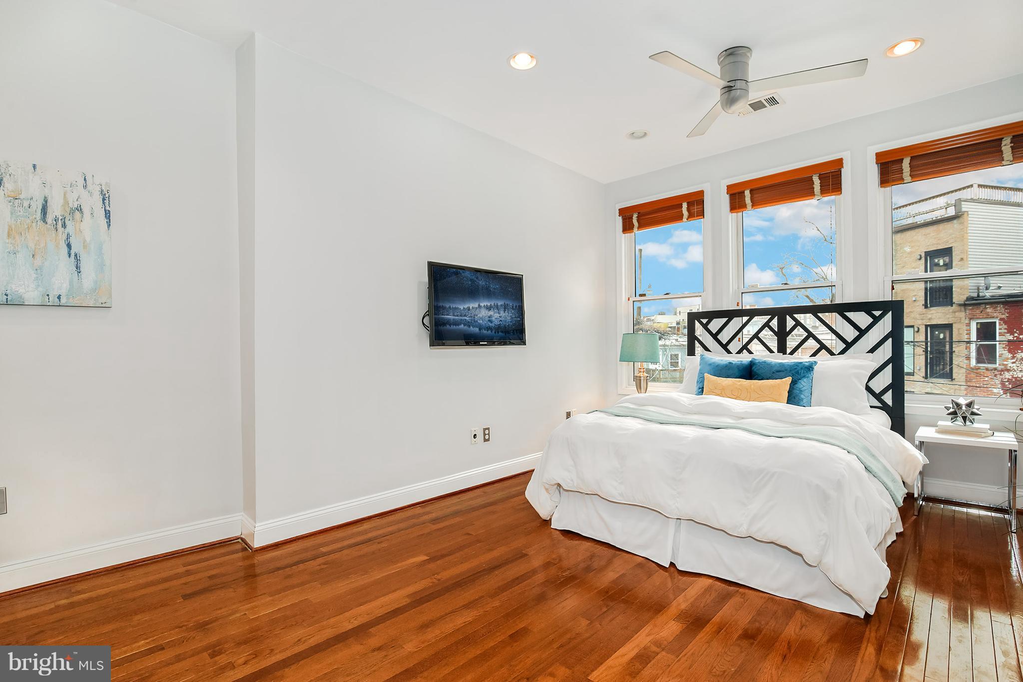 964 Florida Avenue Northwest Washington, DC 20001 - Photo 21 of 27 a bedroom with a large bed and a flat screen tv