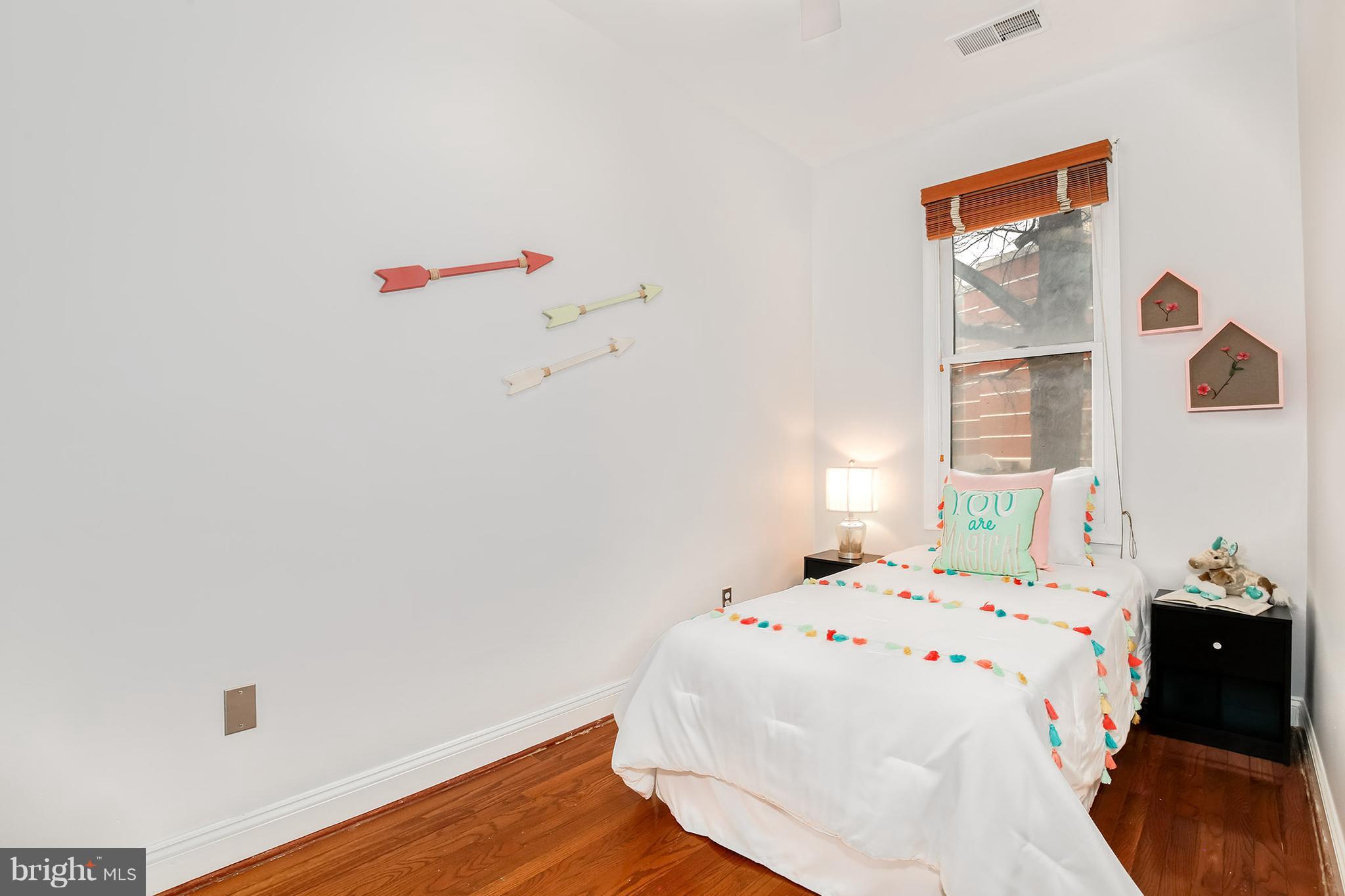 964 Florida Avenue Northwest Washington, DC 20001 - Photo 24 of 27 a bedroom with a bed and a window