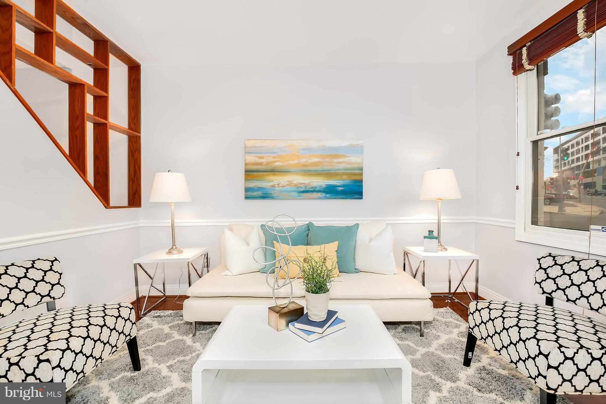 964 Florida Avenue Northwest Washington, DC 20001 - Photo 4 of 27 a living room with furniture and paintings on the wall