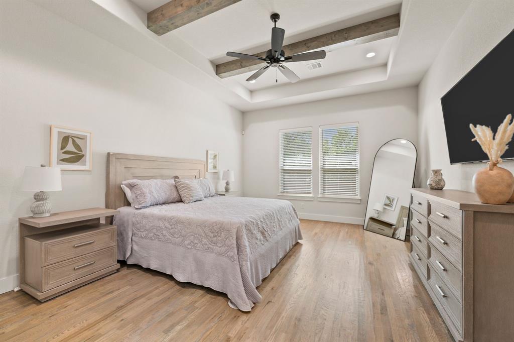200 Clayton Crossing Springtown, TX 76082 - Photo 15 of 40 a bedroom with a bed and a flat tv screen on dresser