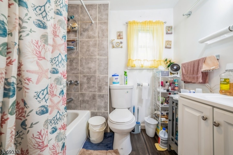 31 Bellevue Avenue Trenton, NJ 08618 - Photo 12 of 21 a bathroom with a toilet and a shower curtain
