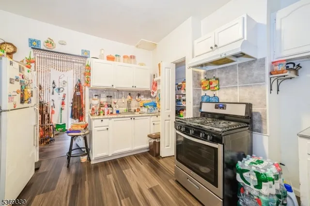 a kitchen with a stove and a refrigerator