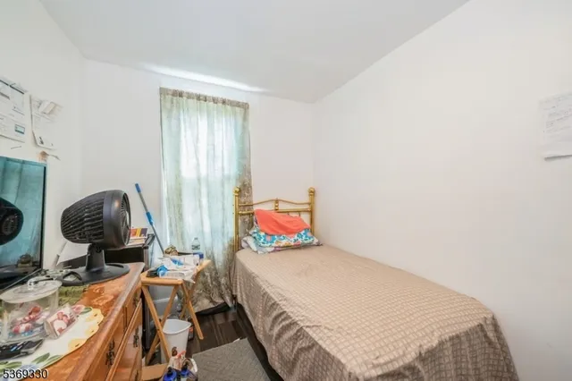 a bedroom with a bed and dresser