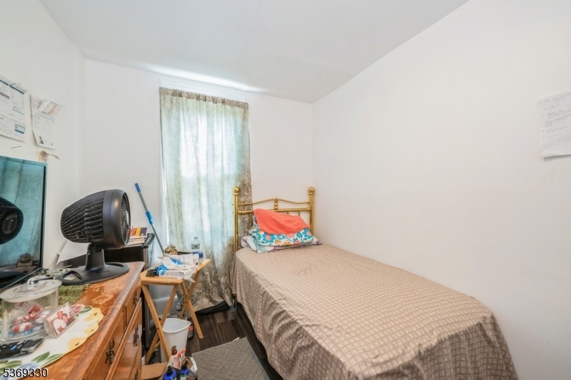 31 Bellevue Avenue Trenton, NJ 08618 - Photo 10 of 21 a bedroom with a bed and dresser