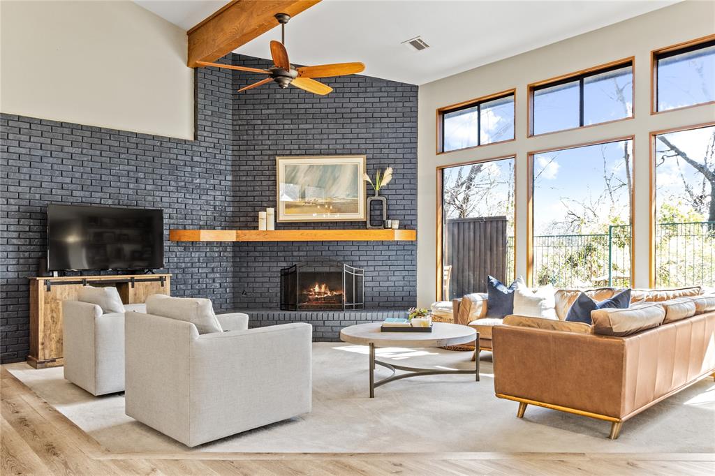 7102 Abrams Road Dallas, TX 75231 - Photo 1 of 1 a living room with furniture a flat screen tv and a fireplace