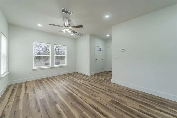 wooden floor in an empty room with a window
