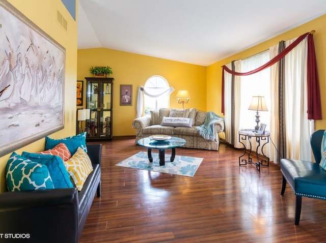 4160 Charleston Road Matteson, IL 60443 - Photo 3 of 15 a living room with fireplace furniture and a large window