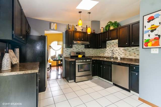 4160 Charleston Road Matteson, IL 60443 - Photo 5 of 15 a kitchen with stainless steel appliances granite countertop a sink stove and refrigerator