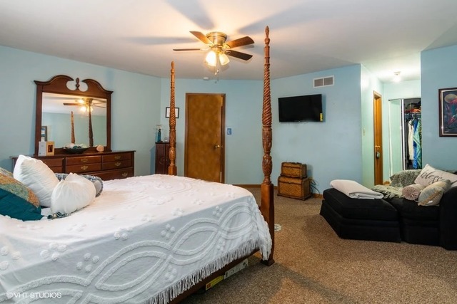 4160 Charleston Road Matteson, IL 60443 - Photo 9 of 15 a bedroom with bed couches and flat screen tv