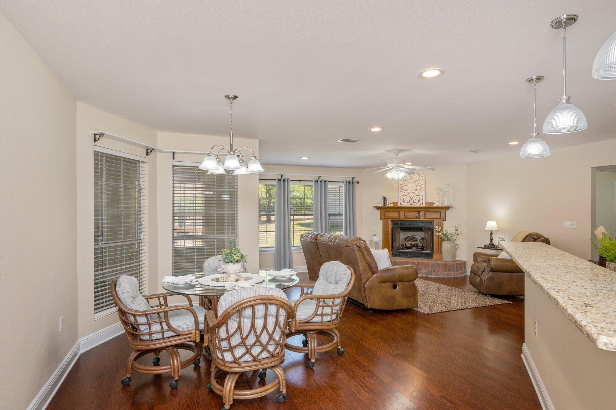 5777 Buckward Road Baker, FL 32531 - Photo 15 of 60 a living room with furniture a fireplace and a chandelier