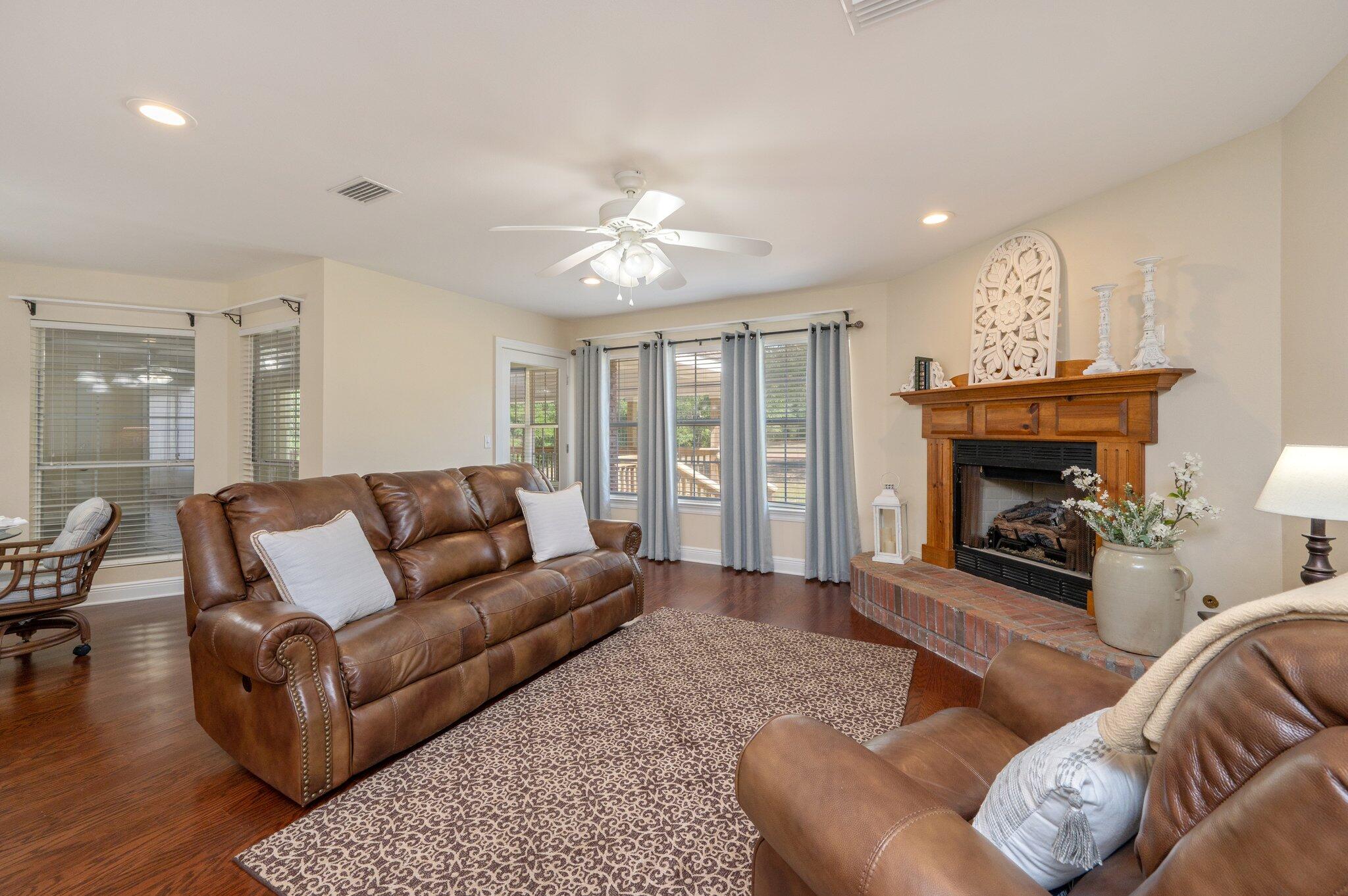 5777 Buckward Road Baker, FL 32531 - Photo 17 of 60 a living room with furniture a fireplace and a chandelier