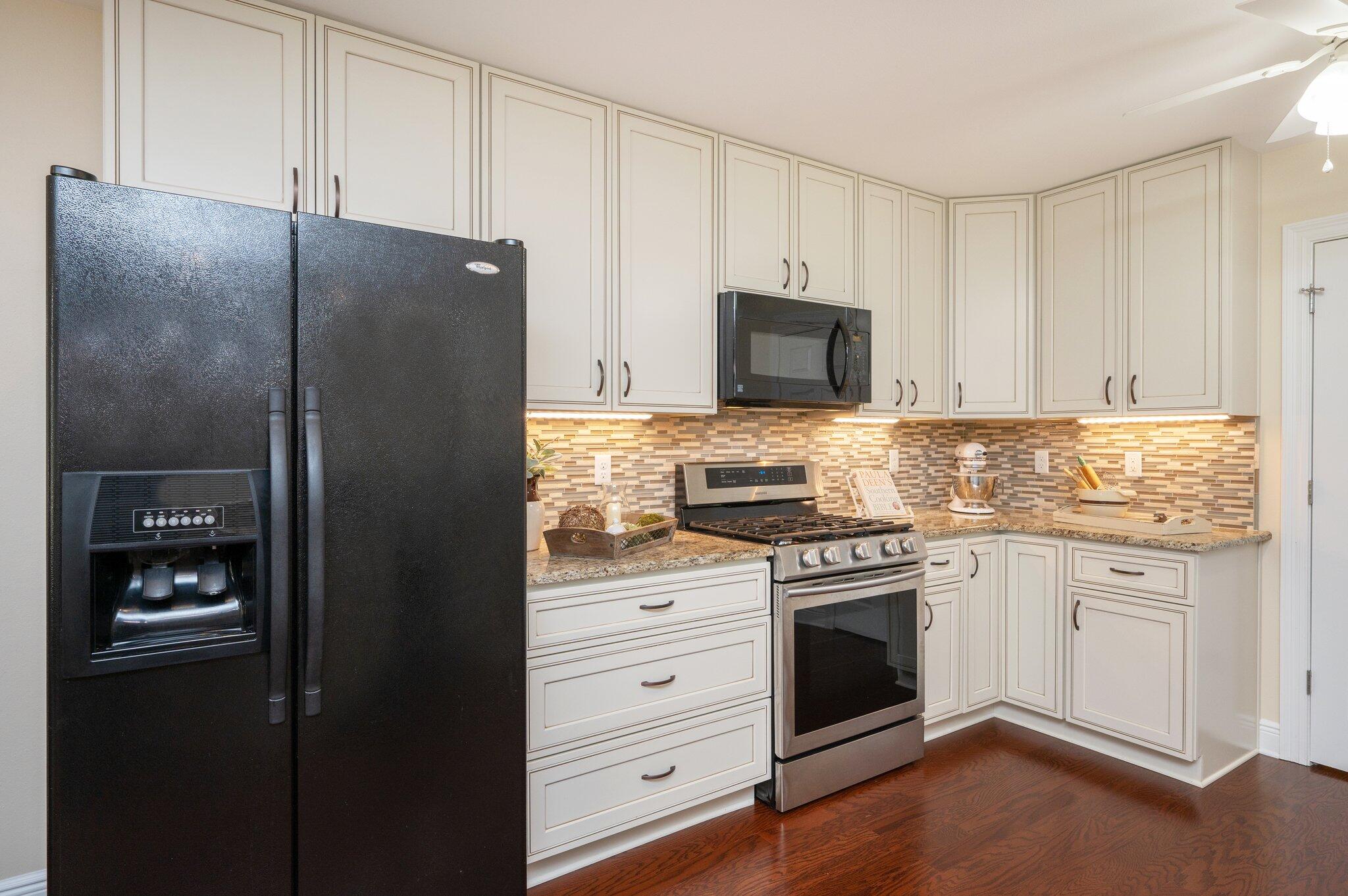 5777 Buckward Road Baker, FL 32531 - Photo 20 of 60 a kitchen with granite countertop white cabinets and stainless steel appliances