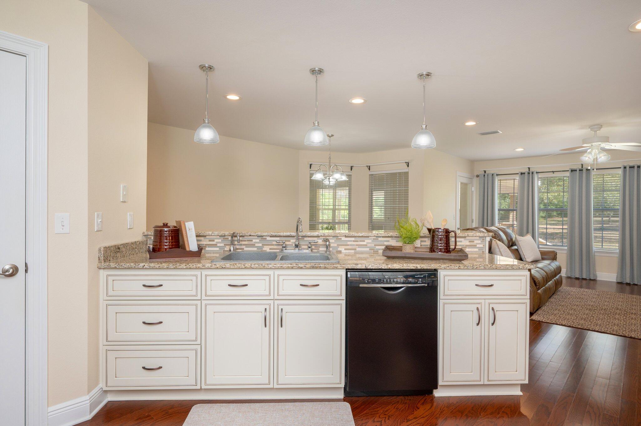 5777 Buckward Road Baker, FL 32531 - Photo 21 of 60 a kitchen with granite countertop a sink a stove and cabinets