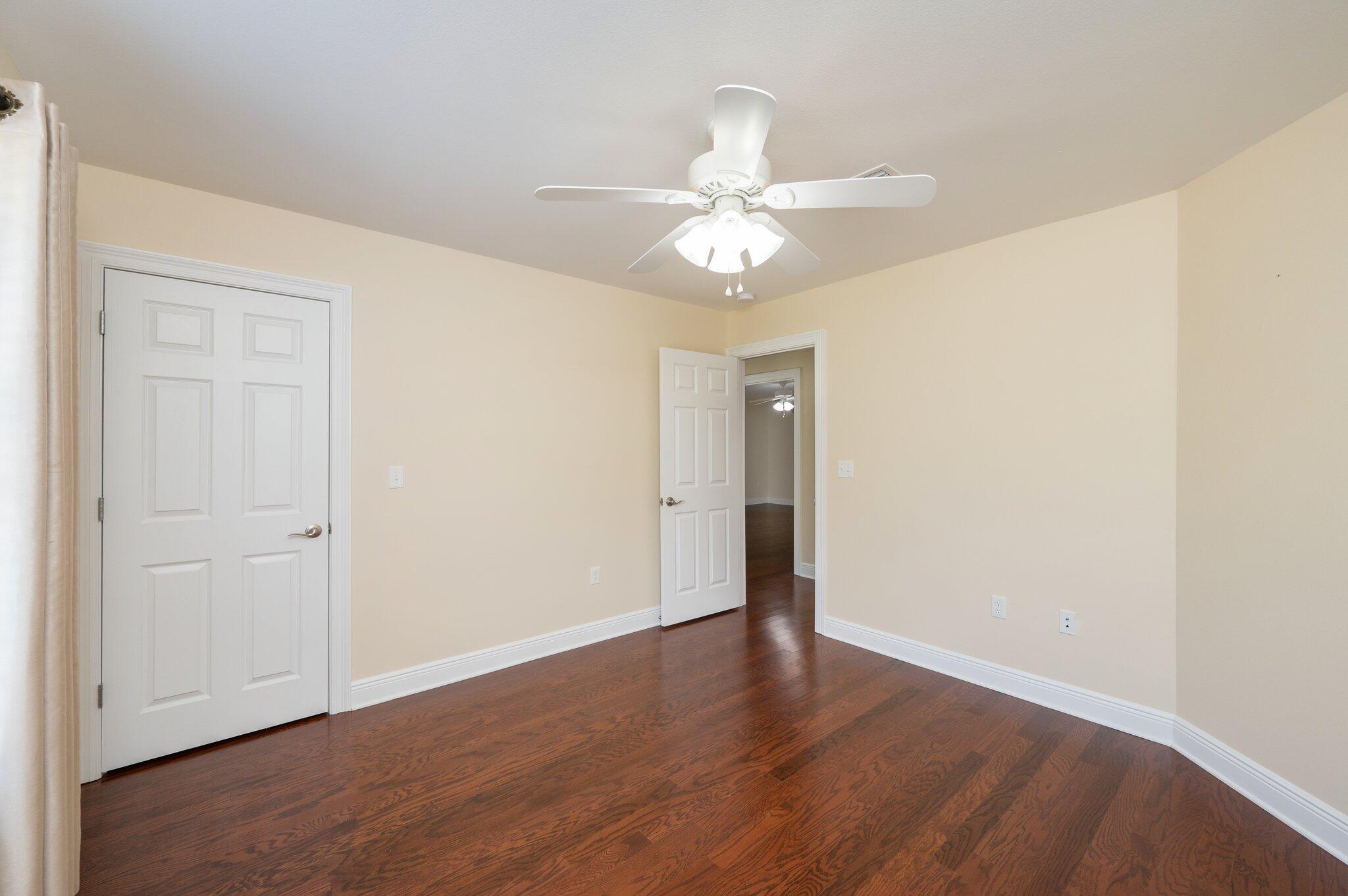 5777 Buckward Road Baker, FL 32531 - Photo 28 of 60 an empty room with wooden floor fan and windows