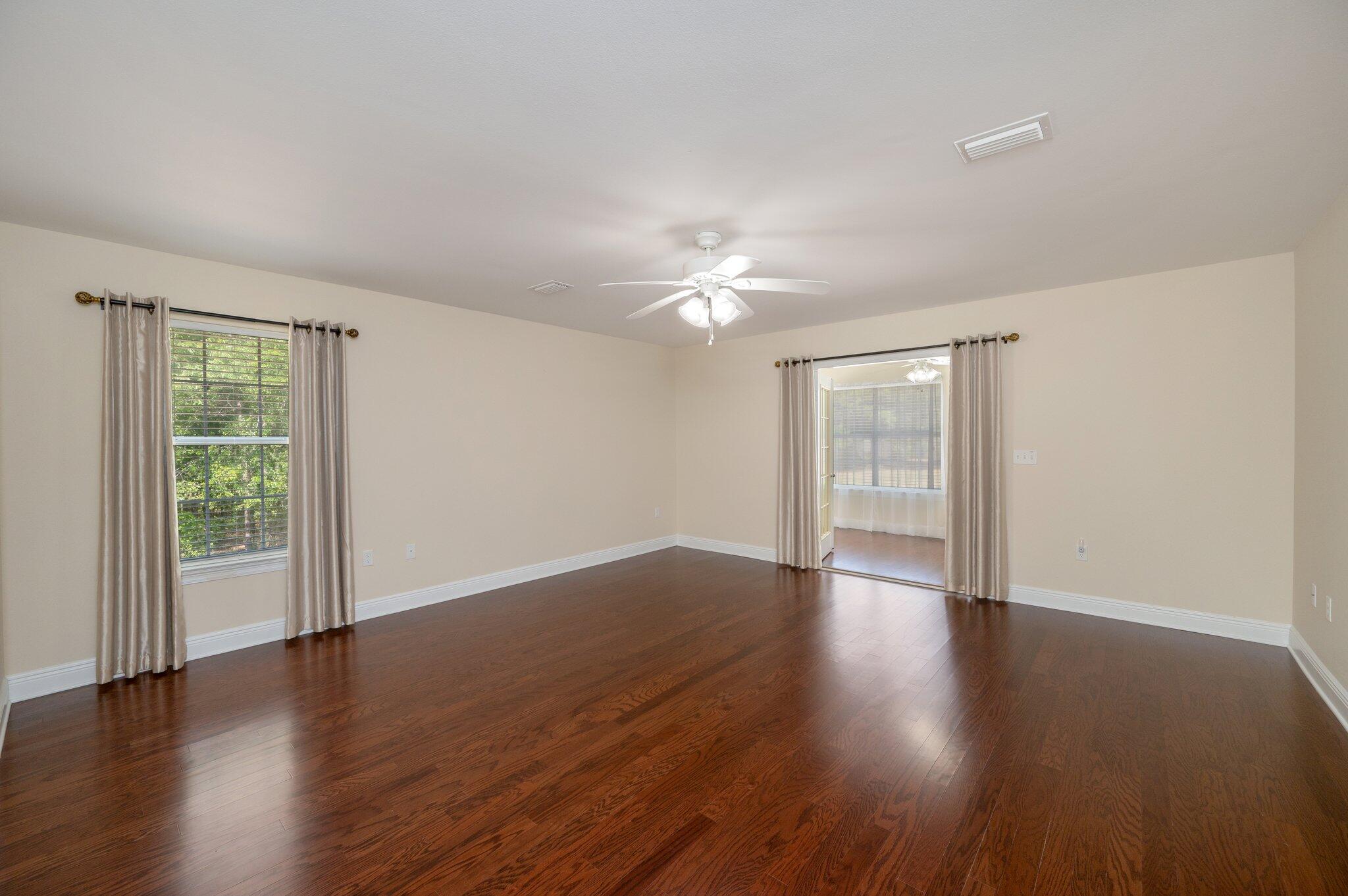 5777 Buckward Road Baker, FL 32531 - Photo 30 of 60 a view of an empty room with wooden floor and a window