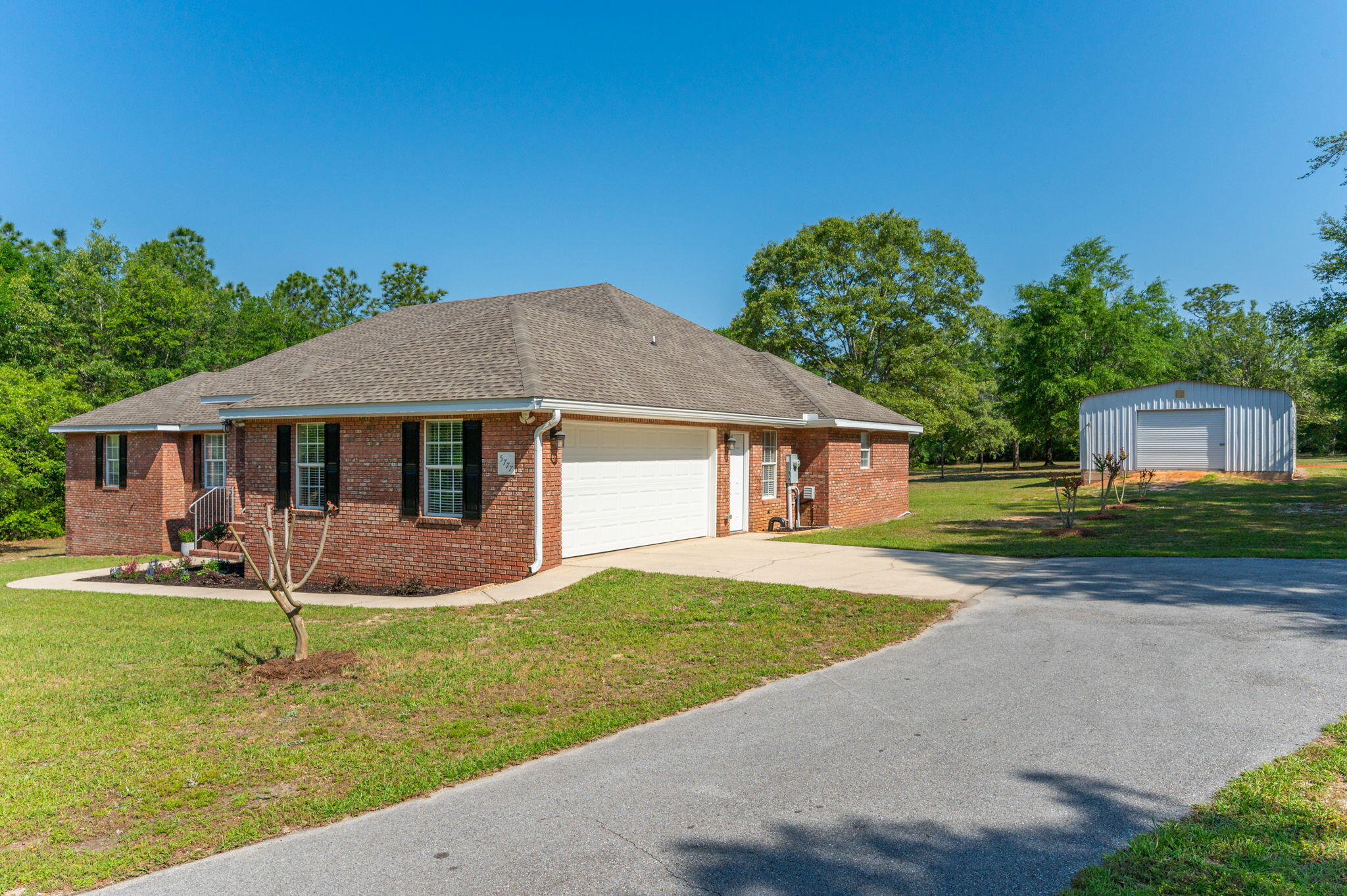 5777 Buckward Road Baker, FL 32531 - Photo 3 of 60 a front view of a house with garden