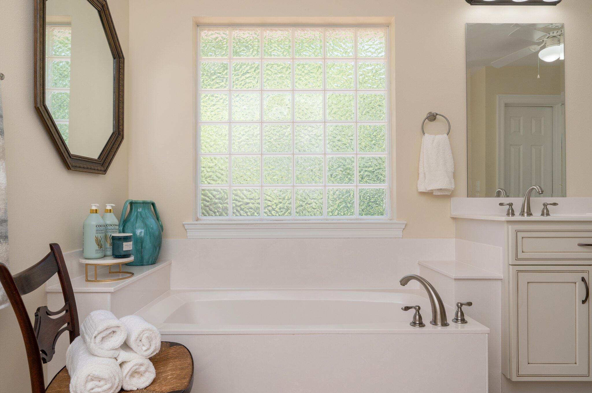 5777 Buckward Road Baker, FL 32531 - Photo 35 of 60 a bathroom with a tub sink and mirror