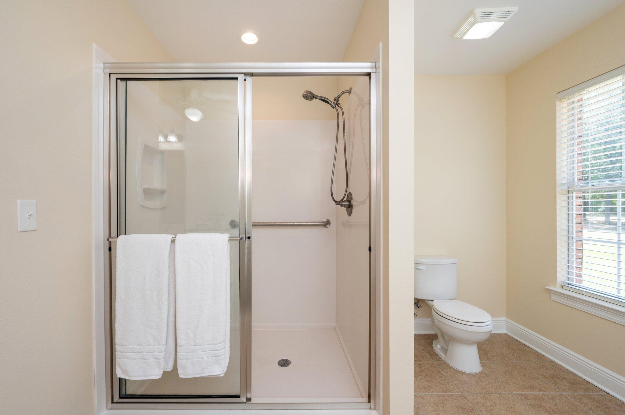 5777 Buckward Road Baker, FL 32531 - Photo 38 of 60 a bathroom with a glass shower door