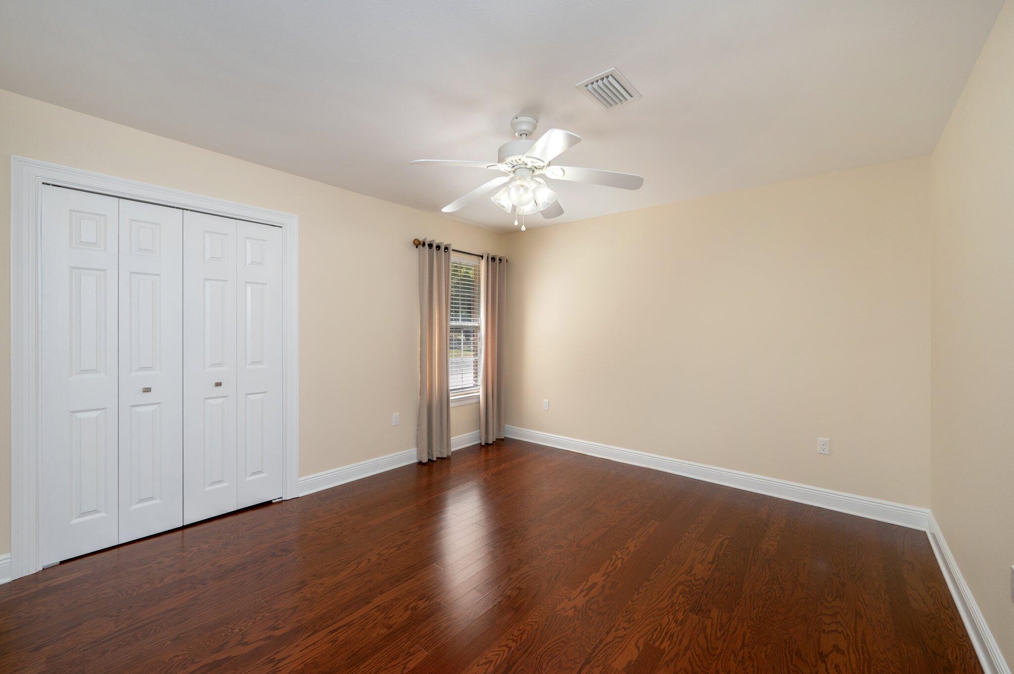 5777 Buckward Road Baker, FL 32531 - Photo 41 of 60 a view of a room with wooden floor and a ceiling fan