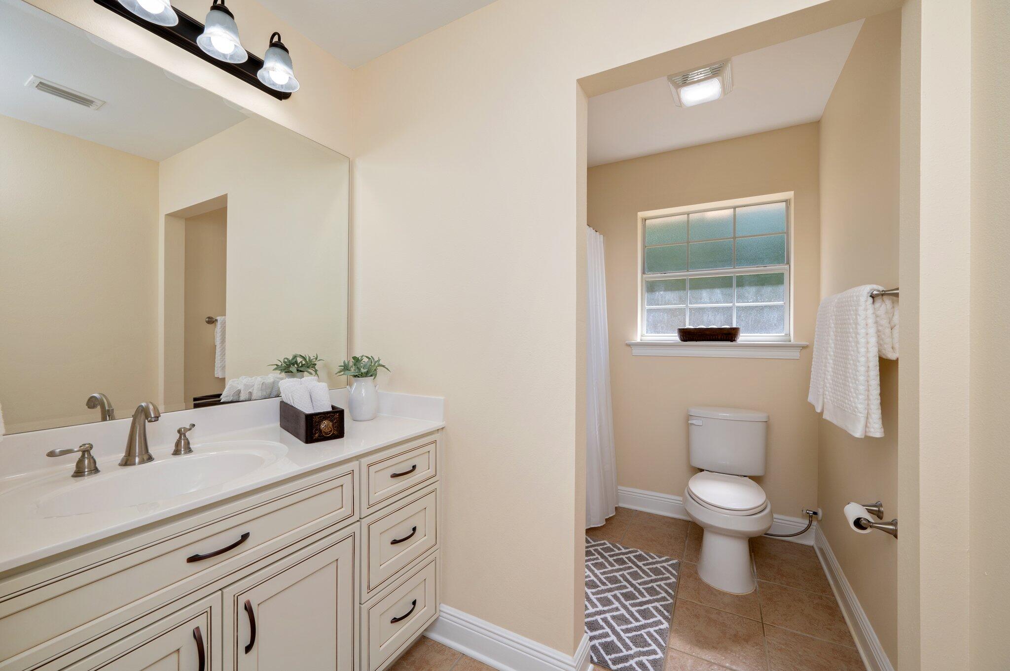 5777 Buckward Road Baker, FL 32531 - Photo 42 of 60 a bathroom with a sink a toilet and a mirror