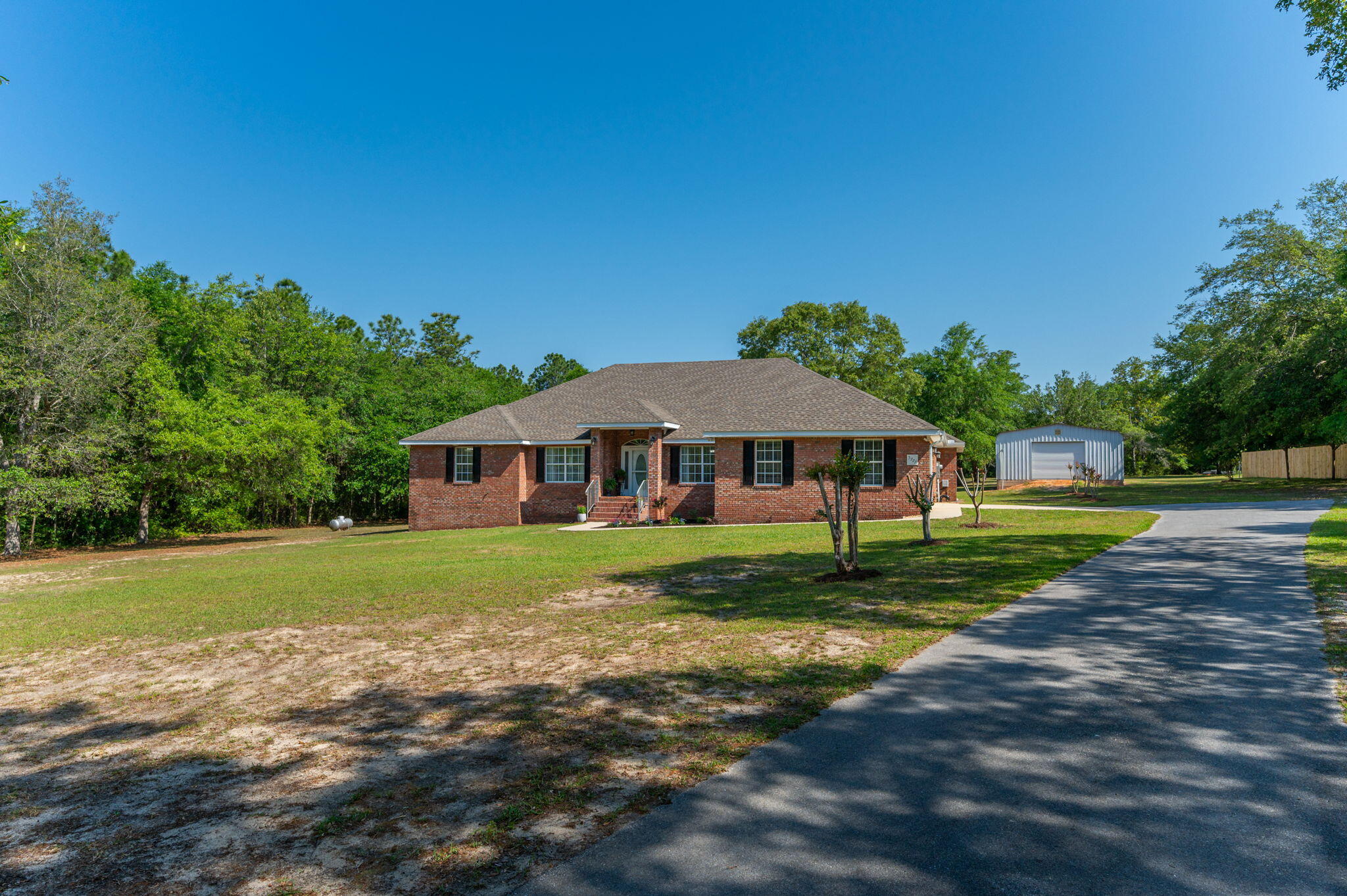 5777 Buckward Road Baker, FL 32531 - Photo 43 of 60 a view of a house with a yard