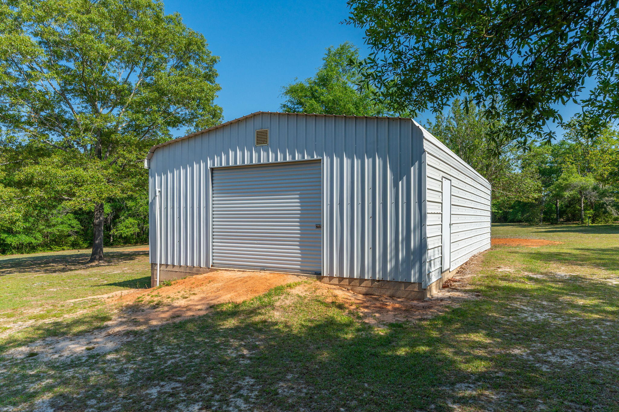 5777 Buckward Road Baker, FL 32531 - Photo 48 of 60 a view of backyard with small cabin and wooden fence