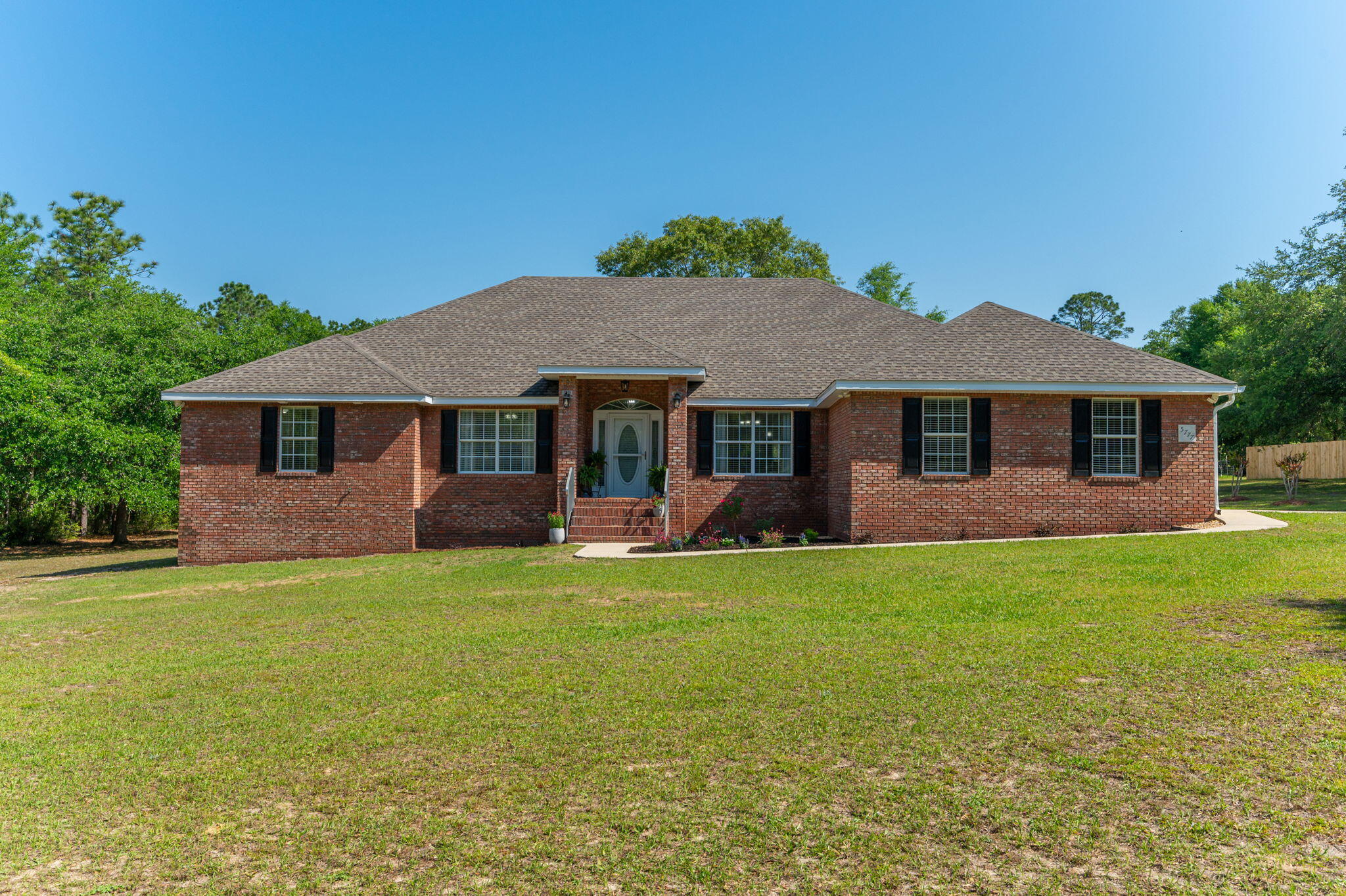 5777 Buckward Road Baker, FL 32531 - Photo 5 of 60 a front view of a house with a garden