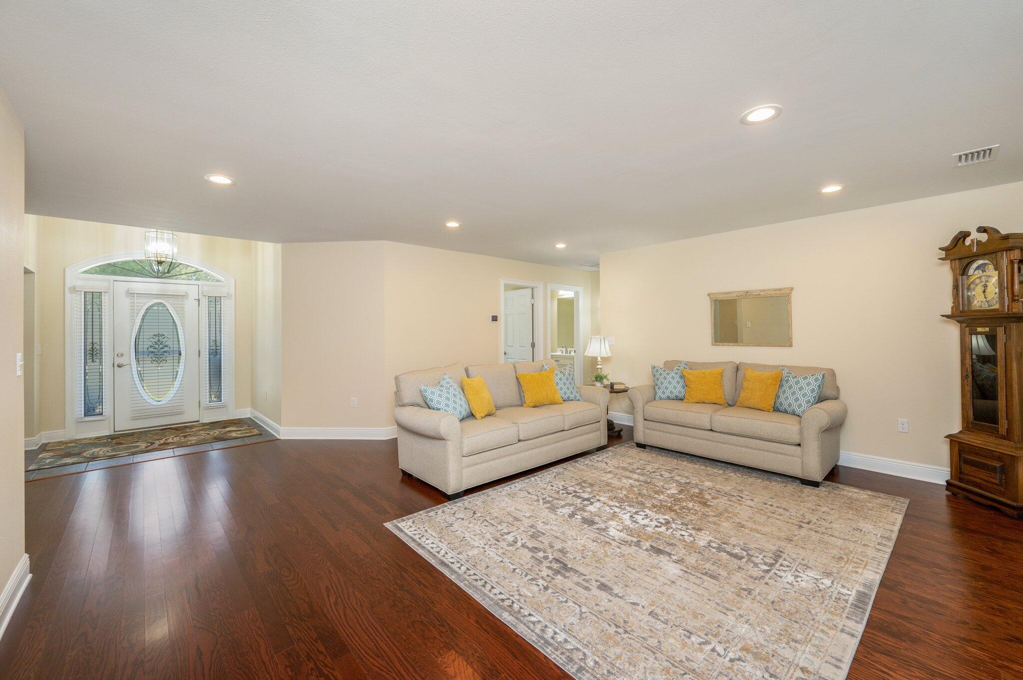 5777 Buckward Road Baker, FL 32531 - Photo 10 of 60 a living room with furniture and a wooden floor
