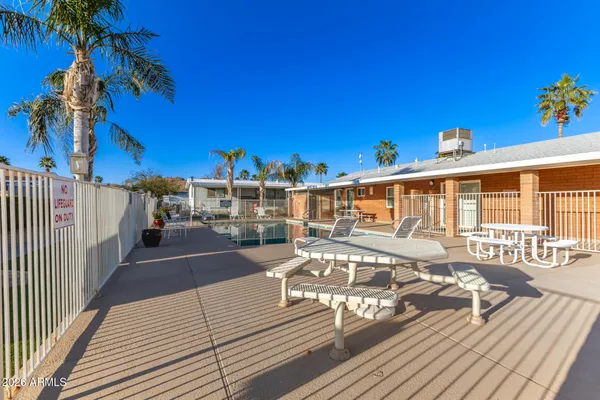 a view of a patio with a table and chairs