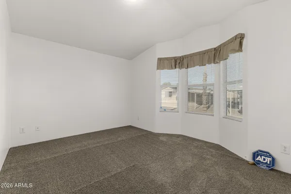 a bathroom with a granite countertop sink a toilet and a mirror
