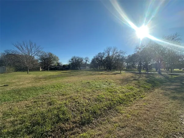 a view of outdoor space with green field and trees all around
