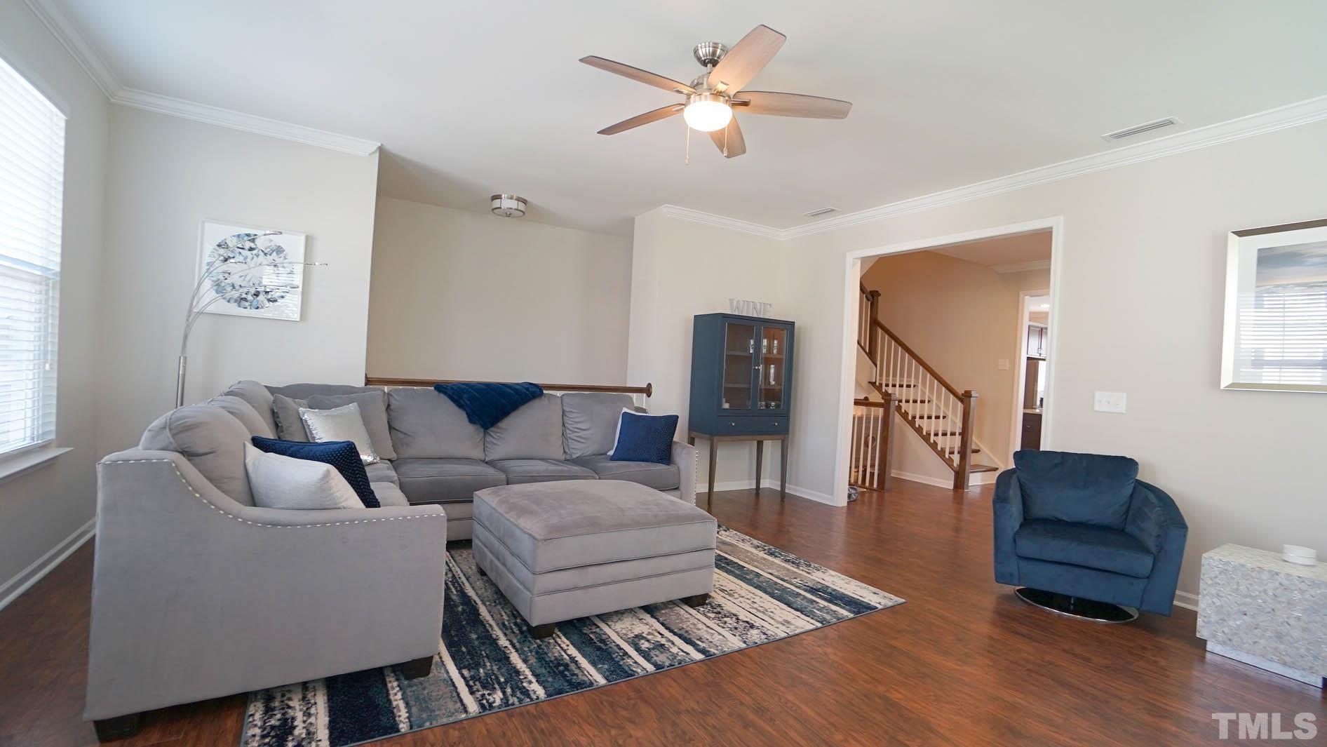 540 Metro Station Apex, NC 27502 - Photo 15 of 45 a living room with furniture a ceiling fan and a window